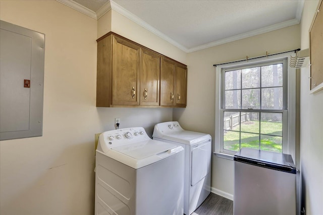 washroom with cabinet space, electric panel, washing machine and dryer, and a healthy amount of sunlight