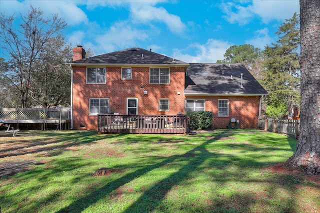 rear view of property featuring brick siding, fence, a lawn, a chimney, and crawl space