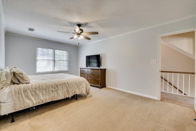 carpeted bedroom featuring a ceiling fan, baseboards, visible vents, ornamental molding, and a textured ceiling