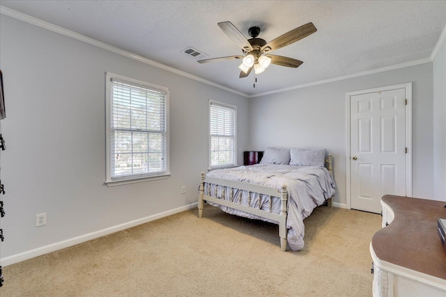 bedroom featuring visible vents, baseboards, ornamental molding, light carpet, and a textured ceiling