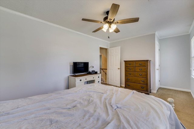 bedroom featuring baseboards, carpet floors, ceiling fan, and crown molding