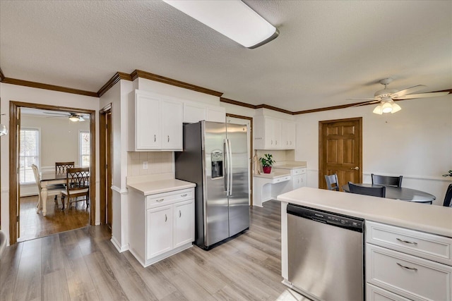 kitchen with light countertops, white cabinets, and stainless steel appliances