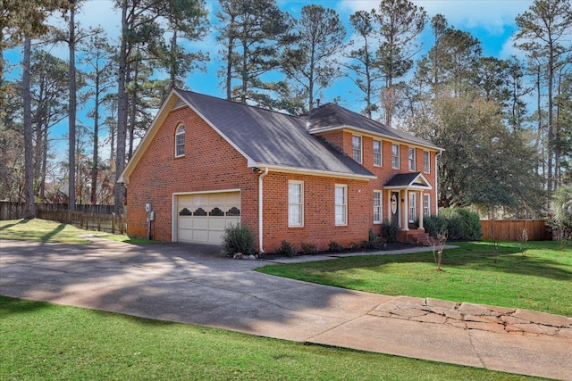 view of front of property with brick siding, concrete driveway, a front yard, and fence