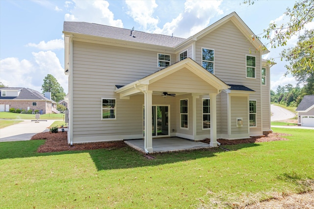 back of property featuring a lawn, ceiling fan, and a patio