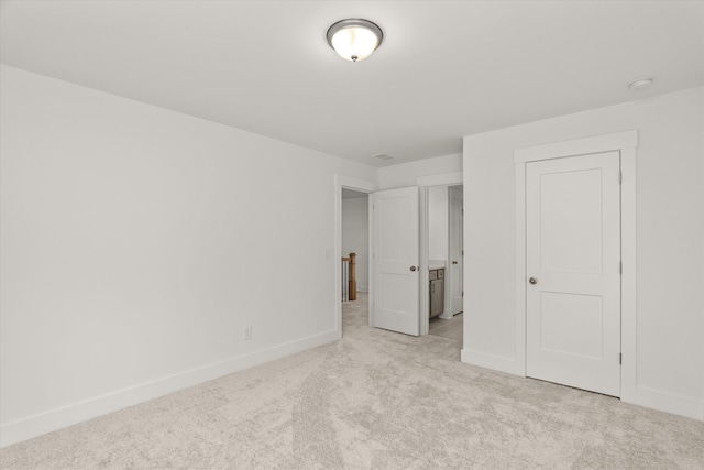 unfurnished bedroom with light colored carpet