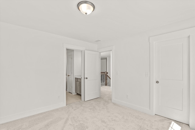 unfurnished bedroom with light colored carpet