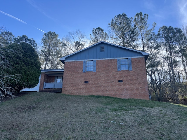 rear view of property with a lawn