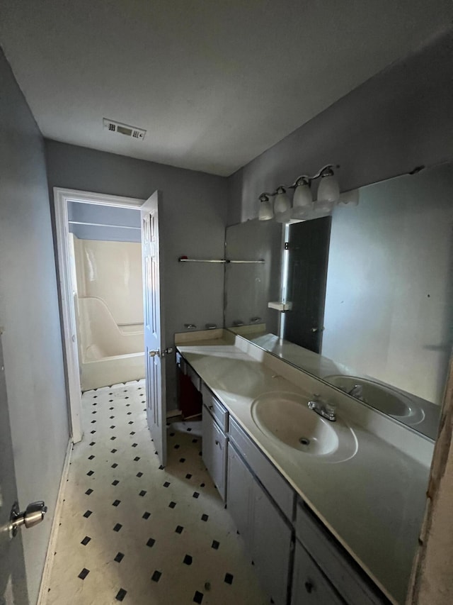 bathroom with shower / bathtub combination and vanity