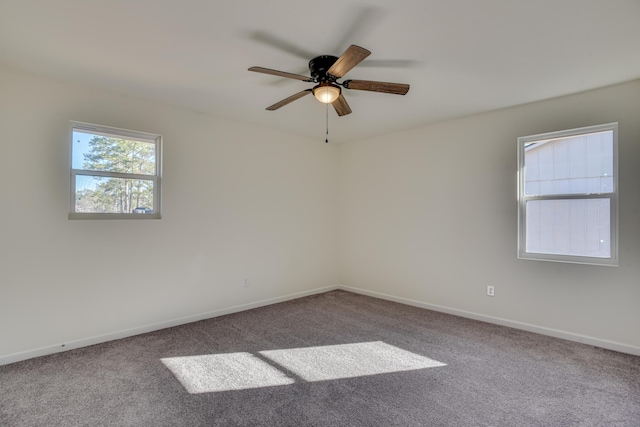 unfurnished room with ceiling fan and carpet