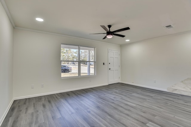 spare room with ceiling fan, crown molding, and hardwood / wood-style floors