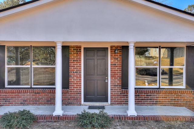 doorway to property featuring covered porch