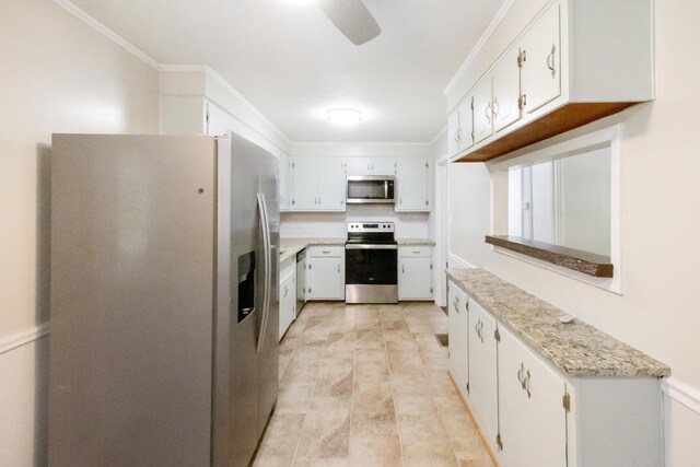 kitchen with light stone countertops, appliances with stainless steel finishes, decorative backsplash, white cabinets, and ornamental molding