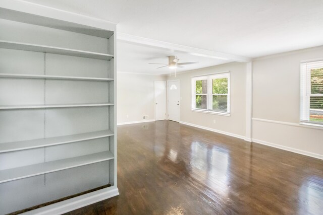 empty room featuring built in shelves, plenty of natural light, and ceiling fan