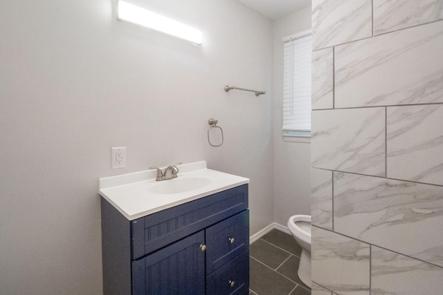 bathroom with tile patterned flooring, vanity, and toilet