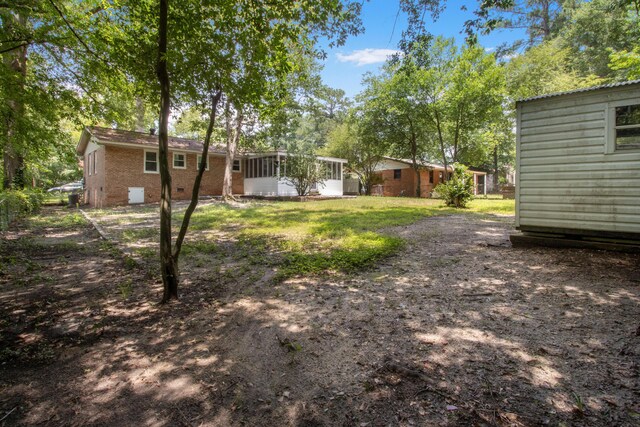 view of yard featuring a sunroom