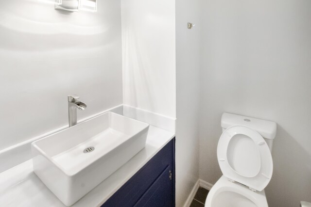 bathroom with tile patterned floors, vanity, and toilet