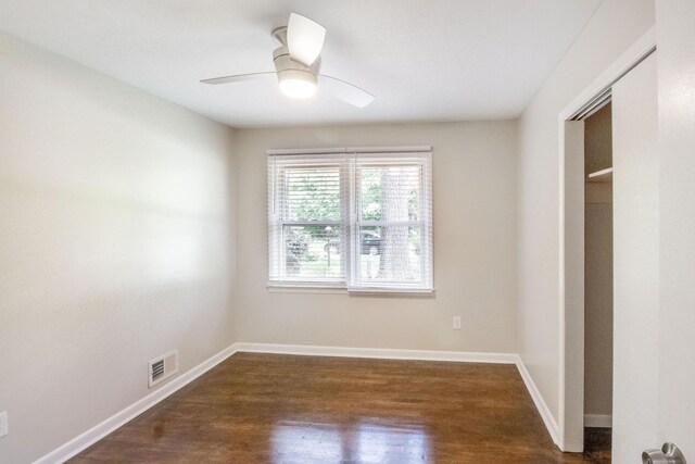 spare room featuring ceiling fan and dark hardwood / wood-style flooring