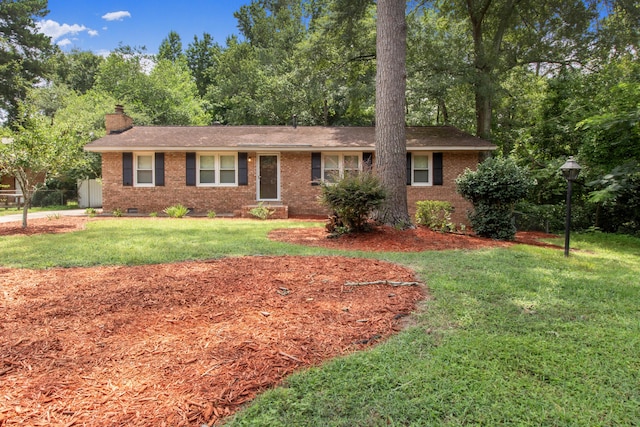 ranch-style home featuring a front yard