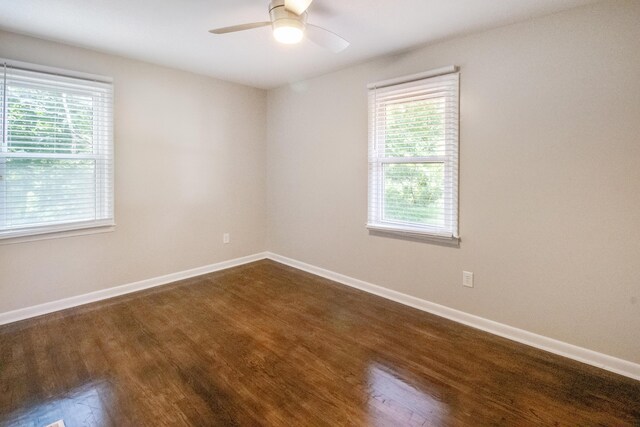 empty room featuring ceiling fan and dark wood-type flooring