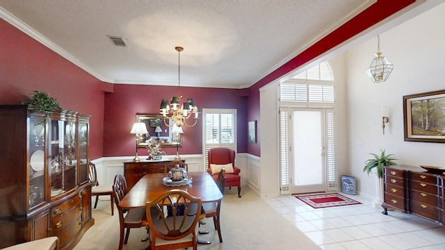 3018 Hillcreek Dr, Augusta, GA 30909 - tiled dining space featuring a chandelier, a wainscoted wall, and crown molding