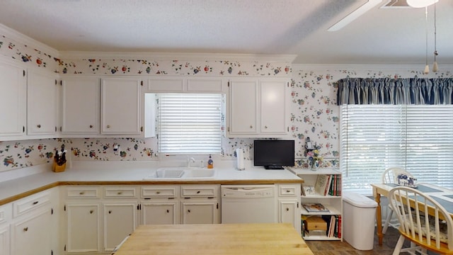 3018 Hillcreek Dr, Augusta, GA 30909 - kitchen featuring dishwasher, a sink, light countertops, wallpapered walls, and ornamental molding