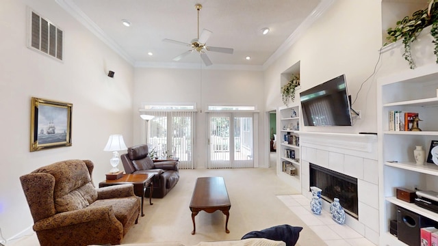 3018 Hillcreek Dr, Augusta, GA 30909 - living area featuring a towering ceiling, crown molding, a ceiling fan, a tile fireplace, and built in features