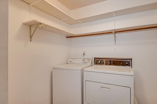 clothes washing area with laundry area and washing machine and clothes dryer