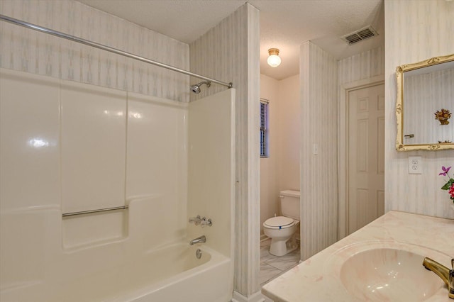 bathroom with vanity, a textured ceiling, visible vents, shower / washtub combination, and toilet