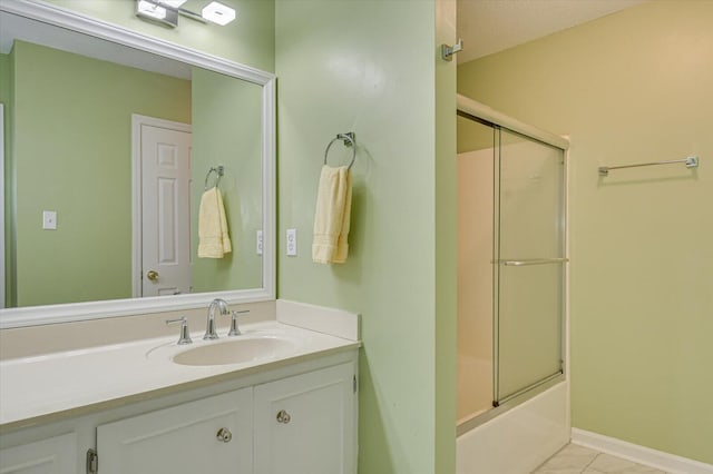 bathroom featuring vanity and bath / shower combo with glass door