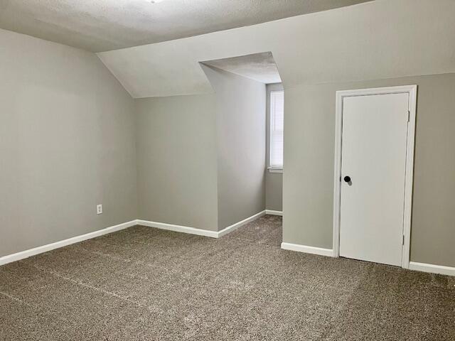 141 Glenora Dr, Martinez, GA 30907 - bonus room featuring carpet floors, baseboards, vaulted ceiling, and a textured ceiling