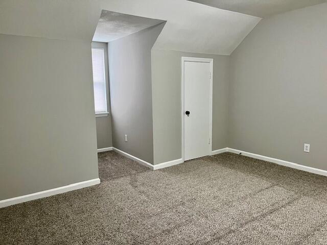 141 Glenora Dr, Martinez, GA 30907 - additional living space featuring baseboards, vaulted ceiling, and carpet floors