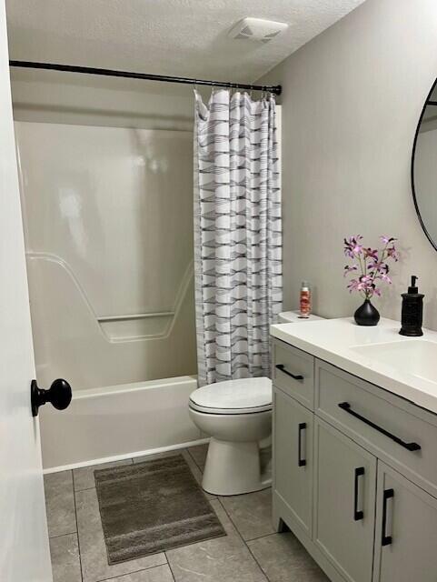 141 Glenora Dr, Martinez, GA 30907 - full bath with shower / tub combo, vanity, tile patterned flooring, a textured ceiling, and toilet