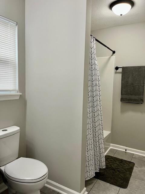141 Glenora Dr, Martinez, GA 30907 - full bathroom featuring baseboards, tile patterned floors, a textured ceiling, a shower with curtain, and toilet