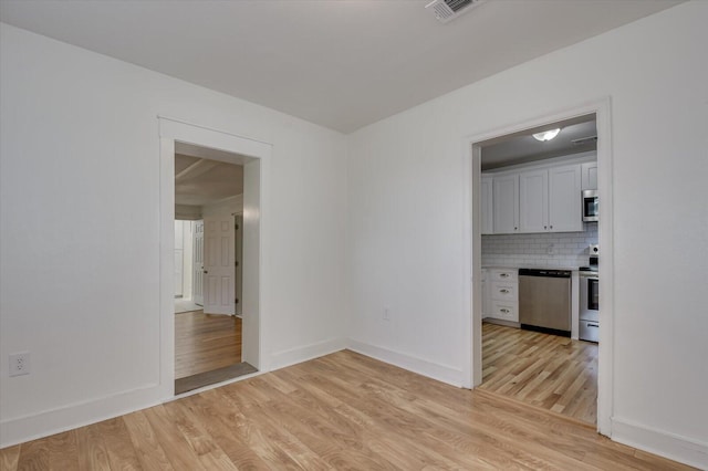 unfurnished room featuring light wood-type flooring