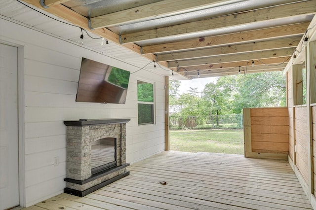 wooden terrace featuring a fireplace