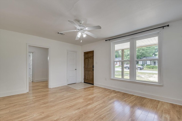 spare room with ceiling fan and light wood-type flooring