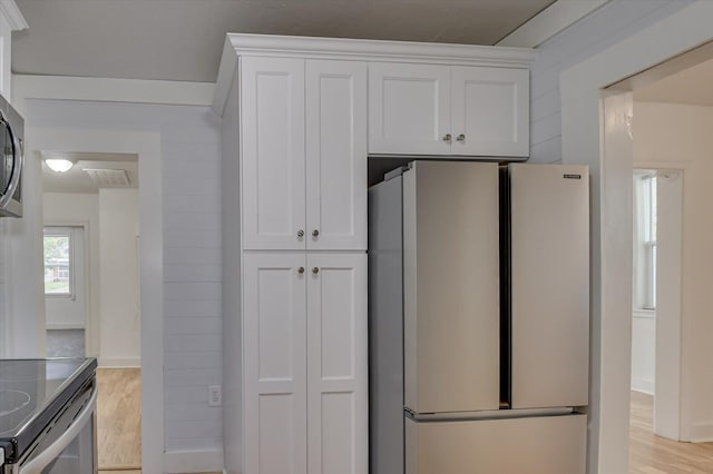 kitchen featuring white cabinets, stainless steel appliances, and light hardwood / wood-style flooring