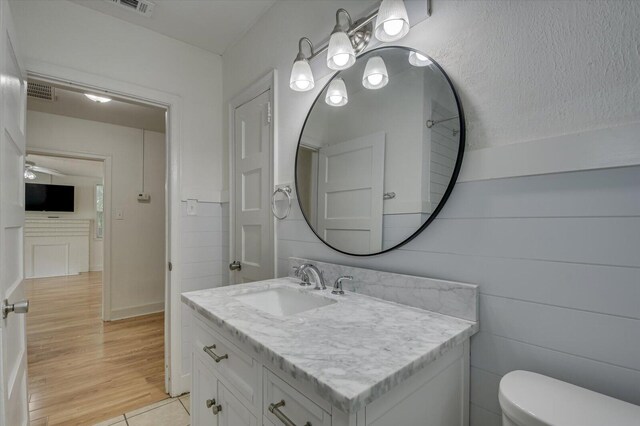 bathroom featuring tile patterned flooring, vanity, toilet, and ceiling fan