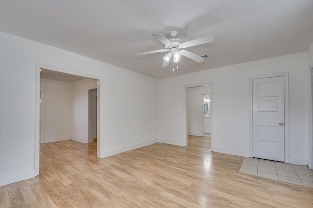 empty room featuring light hardwood / wood-style flooring and ceiling fan