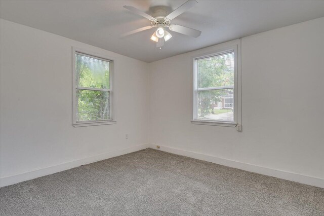 unfurnished room featuring ceiling fan and carpet floors