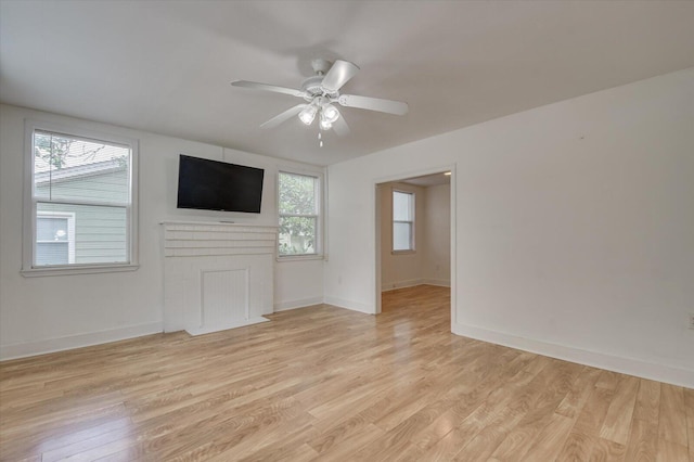 unfurnished living room with ceiling fan and light wood-type flooring