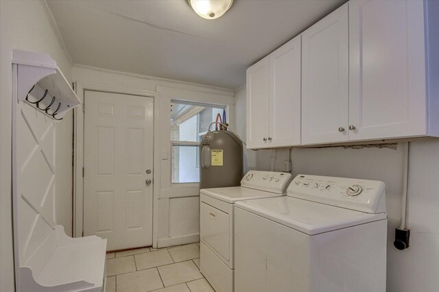 laundry area with washer and dryer, light tile patterned floors, cabinets, and water heater