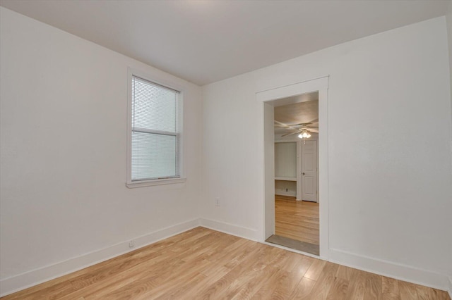 empty room featuring ceiling fan and light wood-type flooring