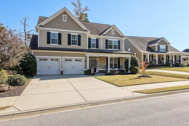 craftsman inspired home featuring a garage, a front yard, and a porch