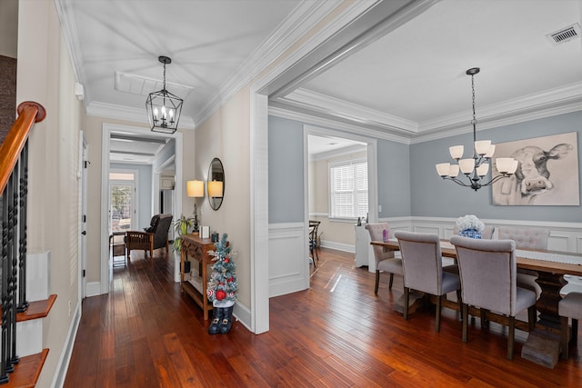 dining room with ornamental molding, dark hardwood / wood-style floors, and a chandelier