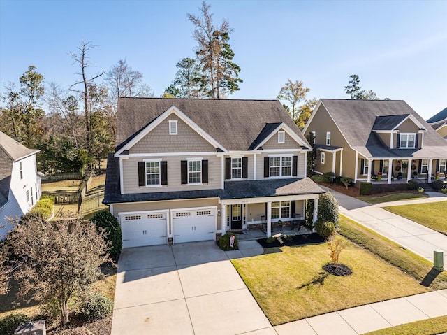 craftsman-style house with a garage, a front lawn, and a porch