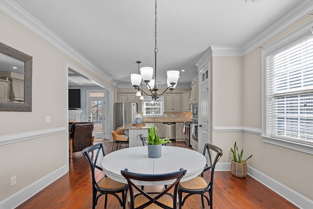 dining area with dark wood-type flooring, crown molding, and a chandelier