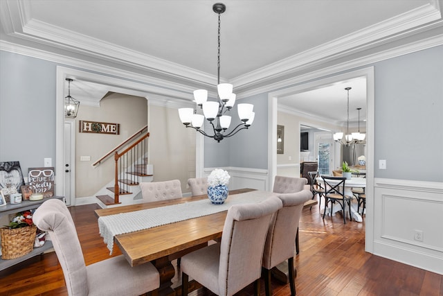 dining area featuring an inviting chandelier, ornamental molding, and dark wood-type flooring