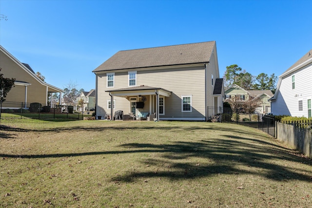 rear view of property with a yard