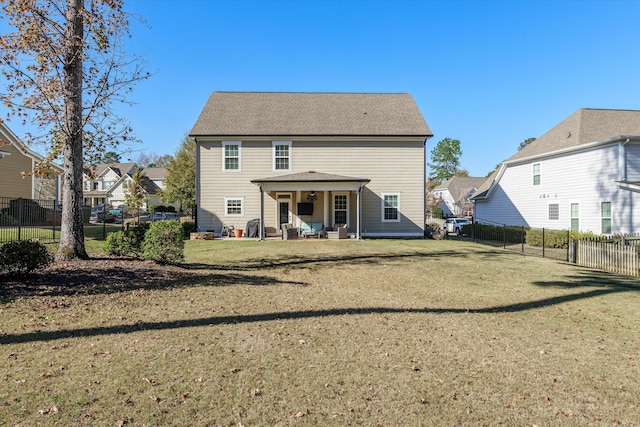 back of house with a lawn